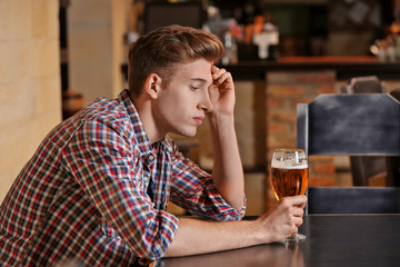 Young man sitting alone in a bar