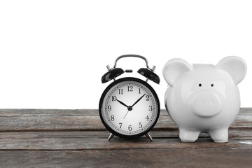 White piggy bank and clock on white background