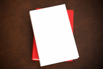 Books on wooden desktop with empty cover