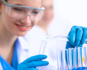 Woman researcher is surrounded by medical vials and flasks, isolated on white background