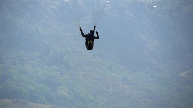 Paraglider leaves the ground and climbs