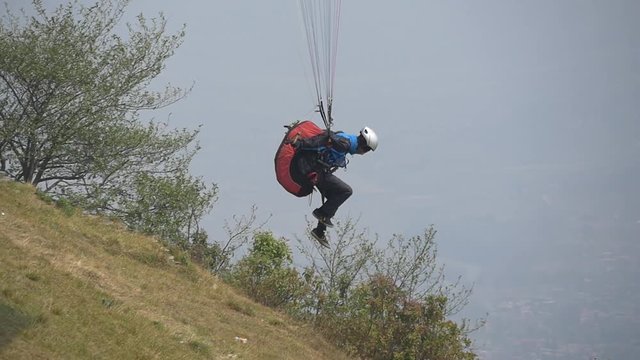 Paraglider flying over the take off at low altitude