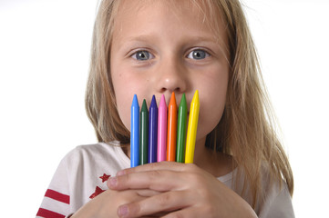 beautiful little girl holding multicolor crayons set in art school children education concept