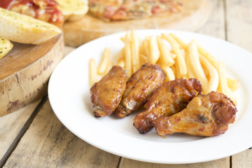 Fast food, crispy chicken wings,bread,french fries and pizza on