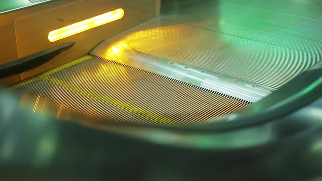 Many people moving on escalator stairs at the airport, railway or bus station