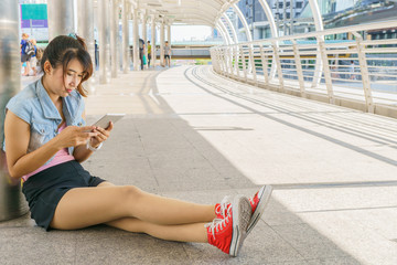 Asian Girl communicate by tablet in urban