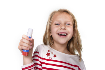 sweet beautiful female child holding glue stick school supplies concept