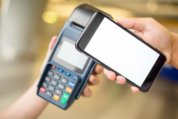 Woman pay by cellphone with NFC technology