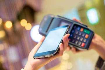 Woman pay with cellphone by NFC technology