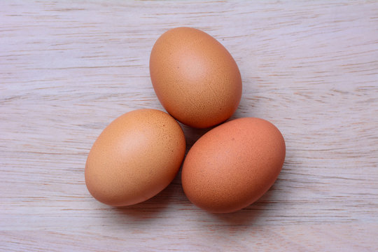 Fresh eggs on wooden background