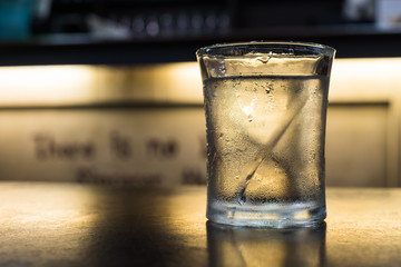 A glass of cold drinking water on table