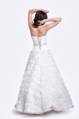 Fototapeta premium Portrait of beautiful young brunette woman bride in white Weddin