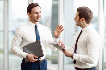Pleasant business partners talking with each other