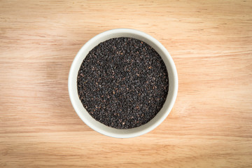 Fototapeta na wymiar bowl of black sesame on a wooden background
