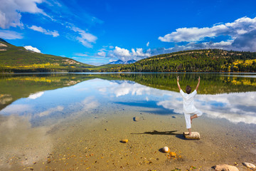 Elderly woman performs yoga, pose 