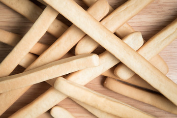 pile of bread stick on a wooden background.