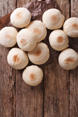 Freshly baked Moroccan bread mkhamer close up. Vertical top view
