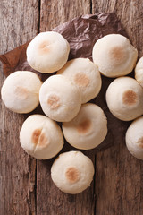 Traditional Moroccan batbout small bread close-up. vertical top view
