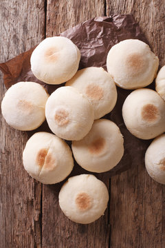 Traditional Moroccan batbout small bread close-up. vertical top view

