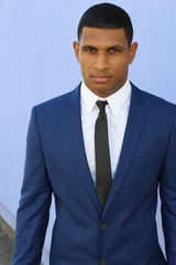 Young handsome businessman in blue suit