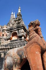 statue of a mythical animal on the background of the temple in Myanmar