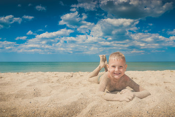Fototapeta na wymiar Kid on a send beach
