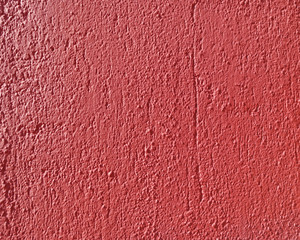 rough red plaster closeup, colorful background