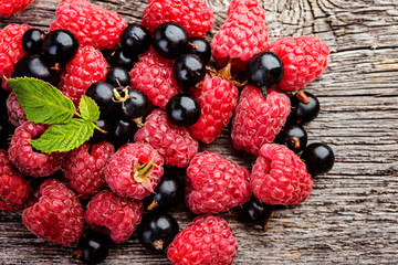  fresh berries on a wooden rustic tablel closeup