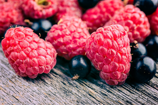  fresh berries on a wooden rustic tablel closeup