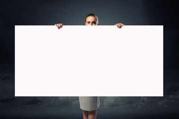 Fototapeta premium Businesswoman with empty placard