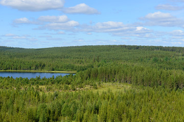 Northern landscape with blue lake. Finnish Lapland
