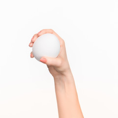 The female hand holding white blank styrofoam oval 