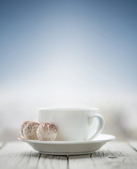 Cup with coffee on the sky background. Breakfast concept and idea
