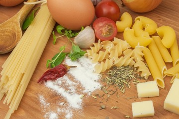 Homework pasta foods. Ingredients for cooking, spread out on the kitchen table. Traditional Italian food. Diet food.
