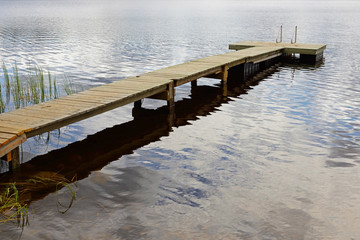 Fototapeta premium Footbridge among clouds. Reflection
