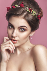 Beautiful young girl with a floral ornament in her hair.Beautiful Woman Touching her Face. Youth and Skin Care Concept