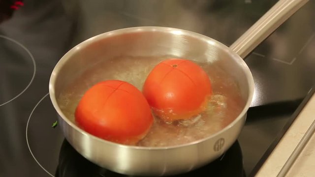 Blanching tomatoes in a stewpan