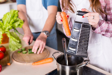 man and woman cooking together