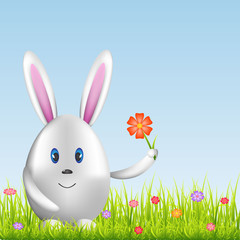 Easter bunny and colorful eggs on spring medow