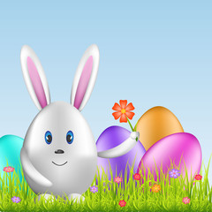 Easter bunny and colorful eggs on spring medow