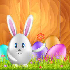 Easter bunny and colorful eggs on spring medow