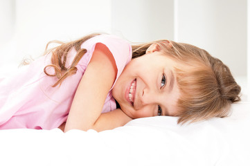 Fototapeta premium Adorable little girl awaked up in her bed