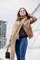 Positive young girl standing on the roof and posing