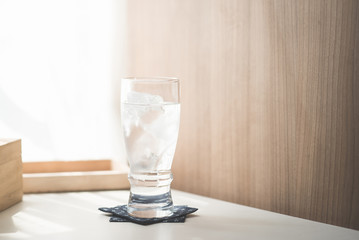 Glasses with ice cubes on wooden table
