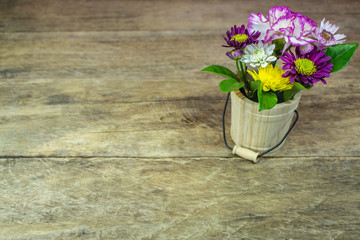 A bouquet of flowers on a wooden floor blank.