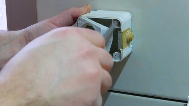 Workers install socket on the wall