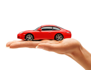 Woman's hand holding a red toy car isolated on white background. Business concept