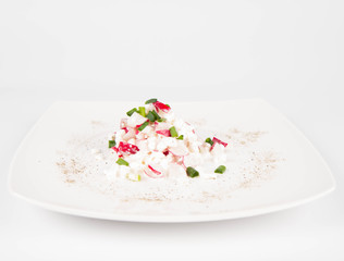Cottage cheese with radish and chives on a white plate