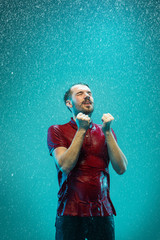 The portrait of young man in the rain