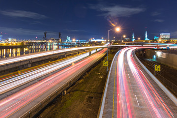 traffic on road with cityscape and skyline of portland at twilig